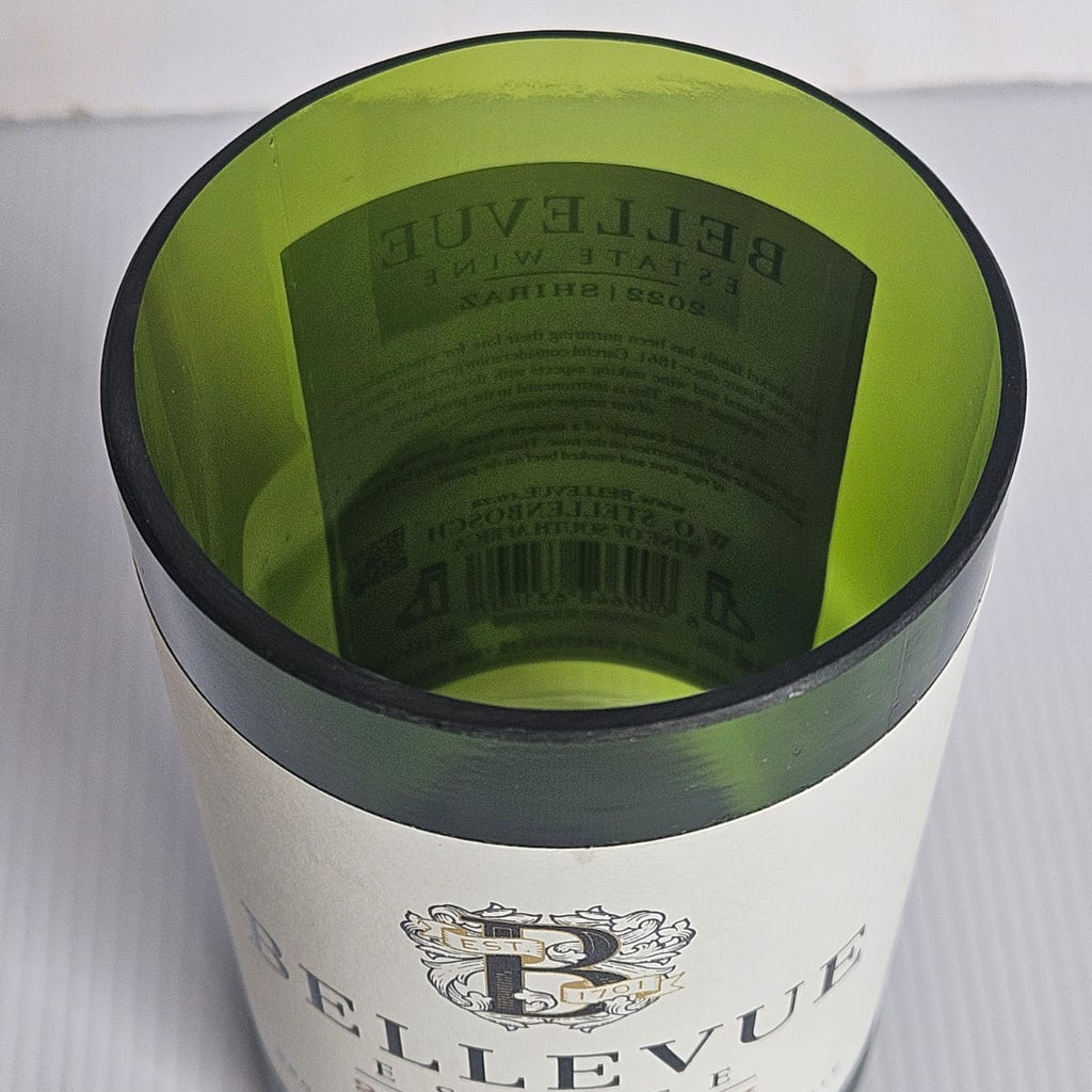 Cut bBellevue Estate wine bottle with green interior on a white background